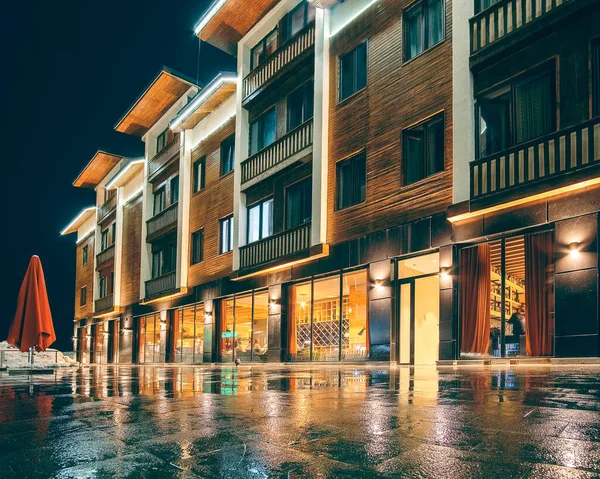 Hotel building is illuminated by night lighting and reflection on the ground Georgia