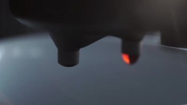 Close-up of falling drops of coffee into a white cup. coffee drops drip from the filter holder of the coffee maker
