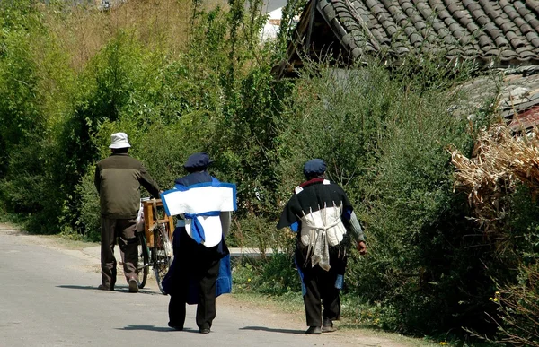 Lijiang, China: Pessoas caminhando ao longo de uma estrada rural — Fotografia de Stock