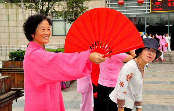 Pengzhou, cnina: Frau mit rotem Fächer beim Tai 'chi — Stockfoto