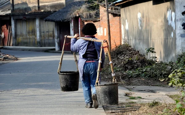 Pengzhou, China: Mulher transportando baldes de água — Fotografia de Stock