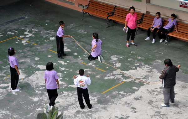 Bangkok, Thajsko: školní děti skákání přes švihadlo — Stock fotografie