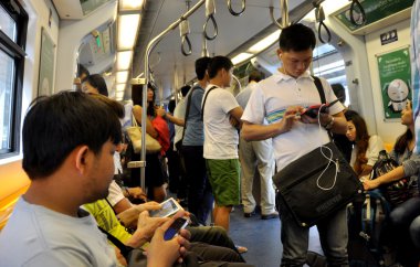 Bangkok, Thailand: Passengers on BTS Skytrain clipart