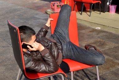 Pengzhou, China: Young Man Talking on Cellphone clipart