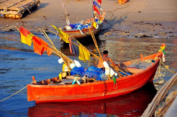 Bang Saen, Thailand: Thai fisherman hauling fishing nets into his