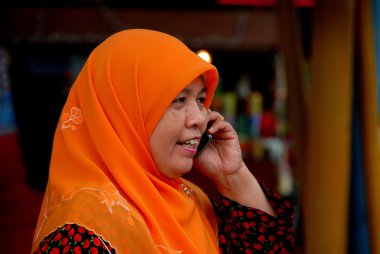 Singapore: Muslim Woman Using Cell Phone clipart