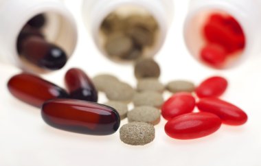 Beyaz şişe üzerinden dökülen kapsül