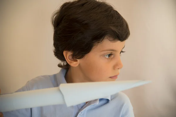 Boy flying sky blue paper aircraft — Stock Photo, Image