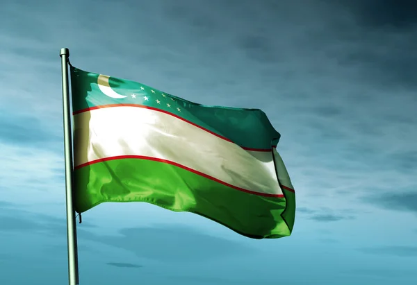 Bandera de Uzbekistán ondeando al viento Imagen de archivo