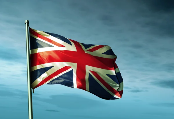 La bandera británica ondeando en el viento Imagen de archivo