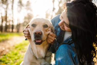 Köpek gülümsüyor. Komik ağızlık. Labrador Retriever. Kız köpekle oynuyor.