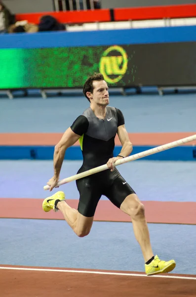 DONETSK, UKRAINE - FEB. 09: Renaud Lavillenie - The Olympic champion 2012 in the pole vault runs up before a jump on Samsung Pole Vault Stars meeting on February 09, 2013 in Donetsk, Ukraine. Stock Photo