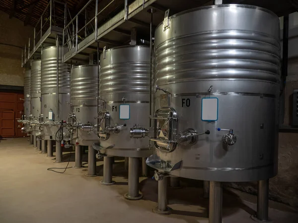 Fermentation in progress. Tankers for fermenting wine inside a wine factory in Catalonia, Spain.