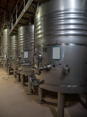 Fermentation in progress. Tankers for fermenting wine inside a wine factory in Catalonia, Spain.