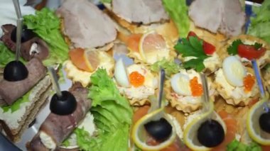 plate with snacks and sandwiches close up