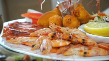 shrimp and other seafood on a plate with lemon