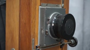 Old wooden gimbal camera. Close-up of a vintage wooden gimbal camera with bellows