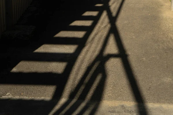 Shadow on the asphalt from an industrial building.