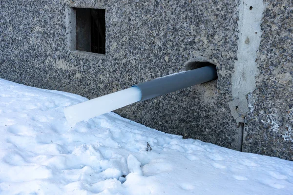 A water pipe in a house with a frozen piece of ice. rainwater harvesting