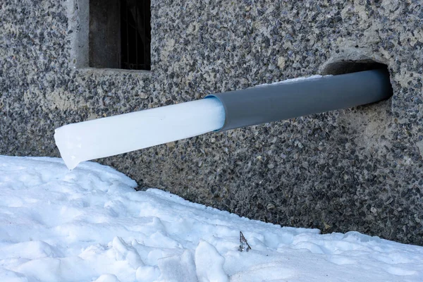 A water pipe in a house with a frozen piece of ice. rainwater harvesting