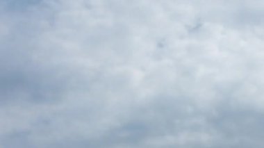 A change in the weather before the downpour. The clouds in the sky change color from bright to dark. Weather change timelapse