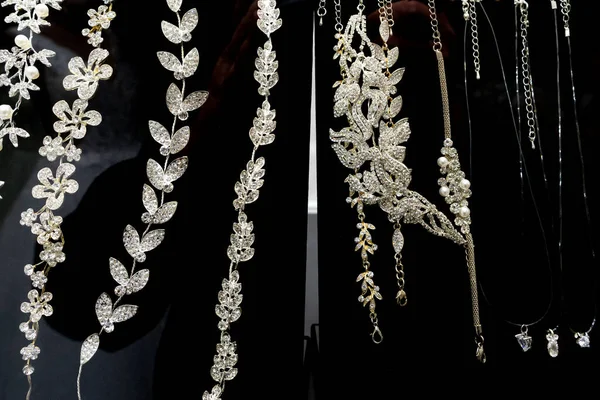 A variety of bride\'s jewelry in the window of a bridal shop.