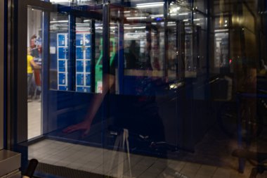 Abstract lighting of the entrance to the night supermarket. Horror.