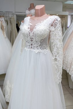 White wedding dresses in a bridal boutique. Copy space
