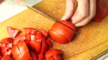 Dicing tomatoes for salad close-up.