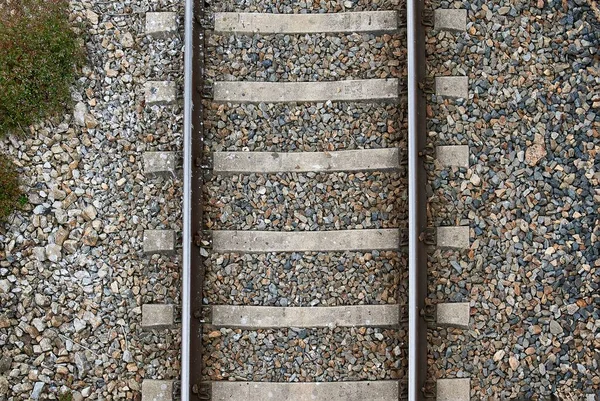 铁路轨道的空中和细节视图 铁路轨道由金属制成 周围有石头作为背景 铁路轨道的空中和细节视图 铁路轨道由金属制成 周围有石头作为背景 — 图库照片