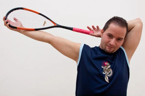 Squash jogador esticar Imagens Royalty-Free
