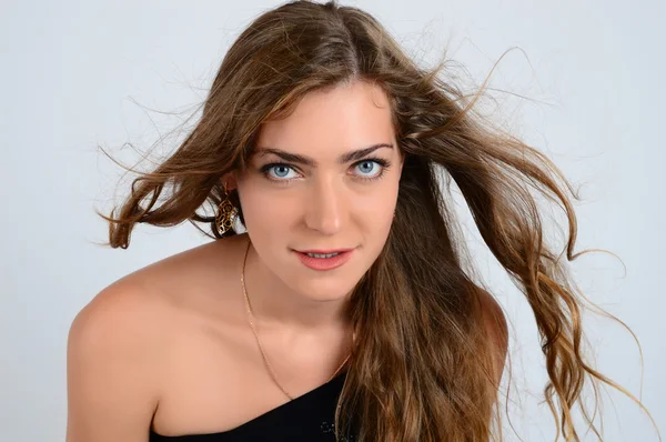 Un retrato de una hermosa modelo con ojos azules y cabello rizado —  Fotos de Stock