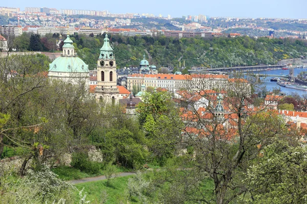 View on the spring Prague with St. Nicholas 'Cathedral, Czech Republic — стоковое фото