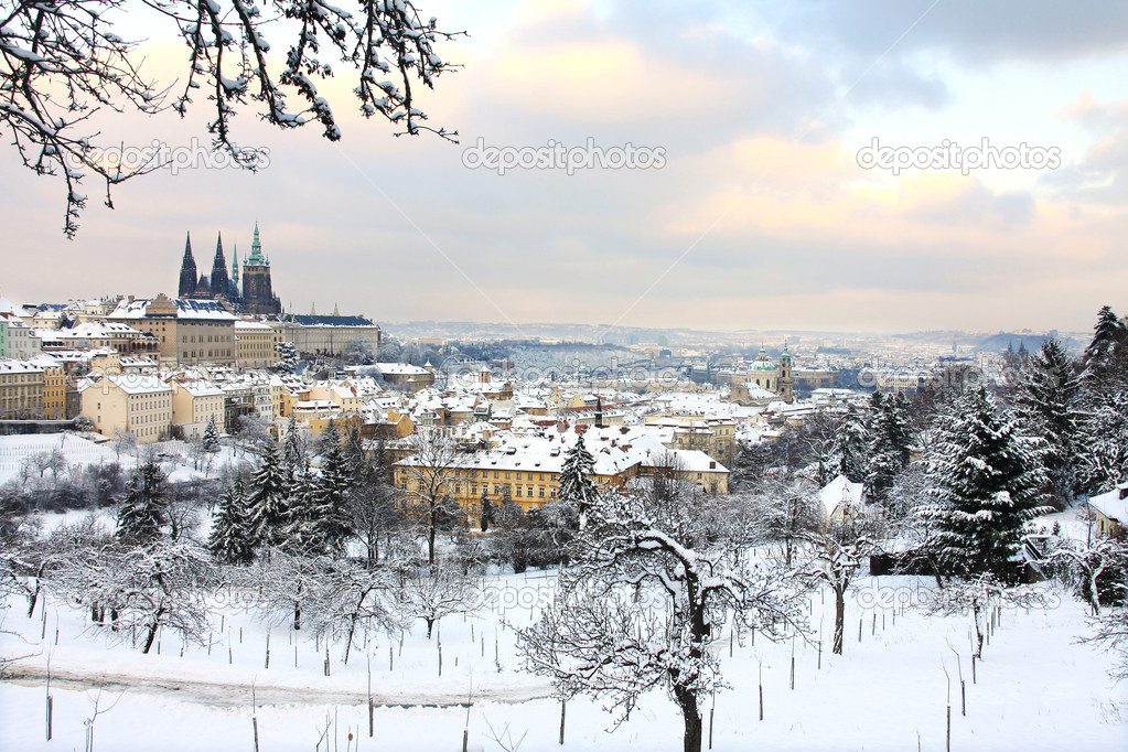 Romantic snowy Prague City with gothic Castle from Strahov Monastery, Czech republic
