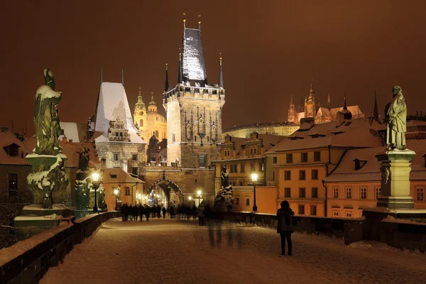 Night snowy Prague gothic Castle, Bridge Tower and St. Nicholas' Cathedral — Stock Photo, Image