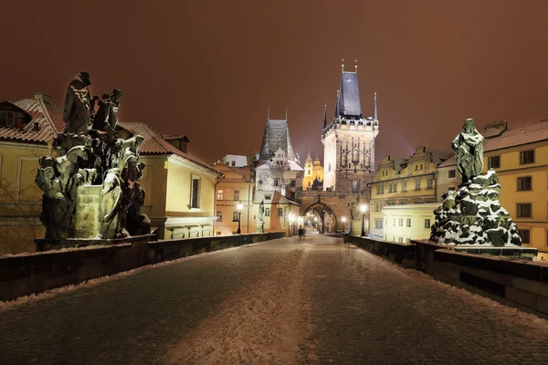 Night snowy Prague Bridge Tower and St. Nicholas' Cathedral from Charles Bridge — Stock Photo, Image