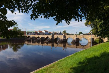 Sunny oldest stone Bridge in central Europe above River Otava, 13th century, Pisek, Czech Republic