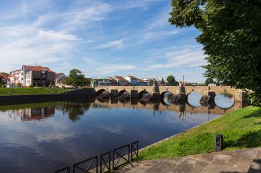 Sunny oldest stone Bridge in central Europe above River Otava, 13th century, Pisek, Czech Republic