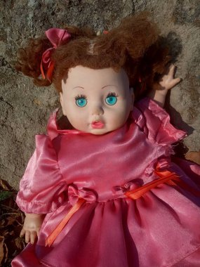 Güzel pembe bir elbise içinde gereksiz bir oyuncak bebek. 