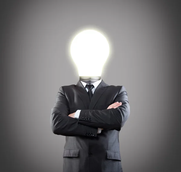 Businessman with glowing light bulb head — Stock Photo, Image