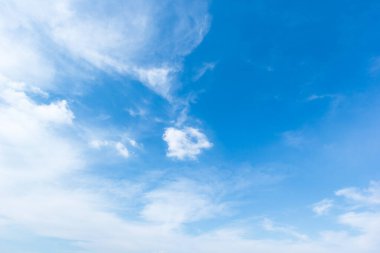 blue sky background with white clouds cumulus floating soft focus.