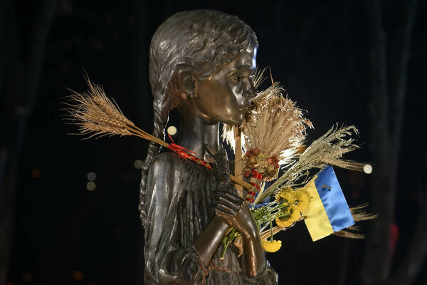 Fragment of Memorial dedicated to victims of the Holodomor (big hunger in Ukraine) 1932 - 1933. Kyiv, Ukraine. November 27, 2021 Girl with spikelets.