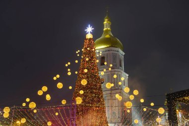 Ukrayna 'nın orta kesimindeki Sofiyska meydanındaki Noel ağacının parlak aydınlatmalı görüntüsü ve Aziz Sophia çan kulesi. Aralık 2021. Yüksek kalite fotoğraf
