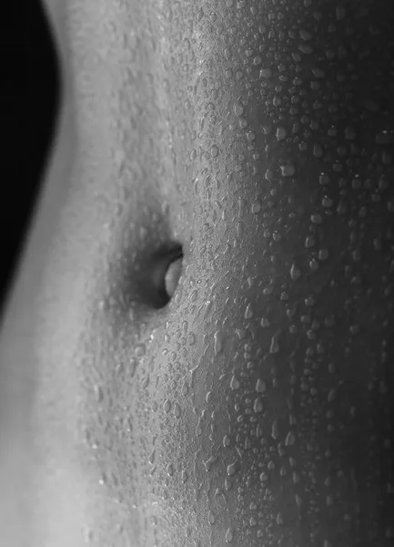 Sexy women's tummy in drops of sweat — Stock Photo, Image