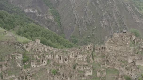 Abandonado en las montañas, el pueblo de Gamsutl. Ciudad fantasma, ruinas de un antiguo asentamiento, fortaleza de montaña inexpugnable en las montañas de Daguestán. Vista aérea de un antiguo pueblo. Dlog-M 10 bit — Vídeo de stock