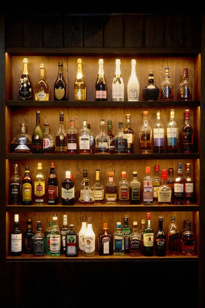 Bottles With Alcoholic in a bar. Bottles of alcoholic beverages are on the shelves. Bar on the wall. 06.06.2021, Rostov region, Russia Stockfoto