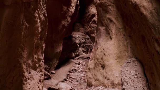 ドローン山の中で狭い峡谷を飛んでいます。水によって作られた狭い暗い峡谷。地面の地溝帯、高古代の崖の壁。手付かずの自然の素晴らしい美しさ。宇宙旅行だ。10ビットビデオ — ストック動画