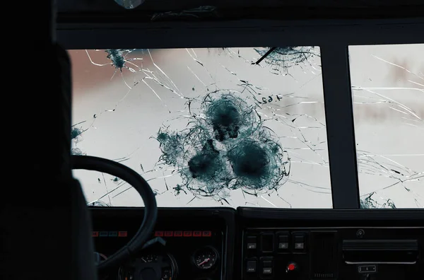 Armored glass after of a direct hit from an automatic weapon. Safety glass after being hit by a bullet. Bulletproof glass armored car after gunshot — Stock Photo, Image