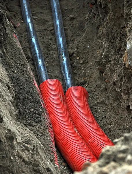 Pipes are laid in a hole — Stock Photo, Image