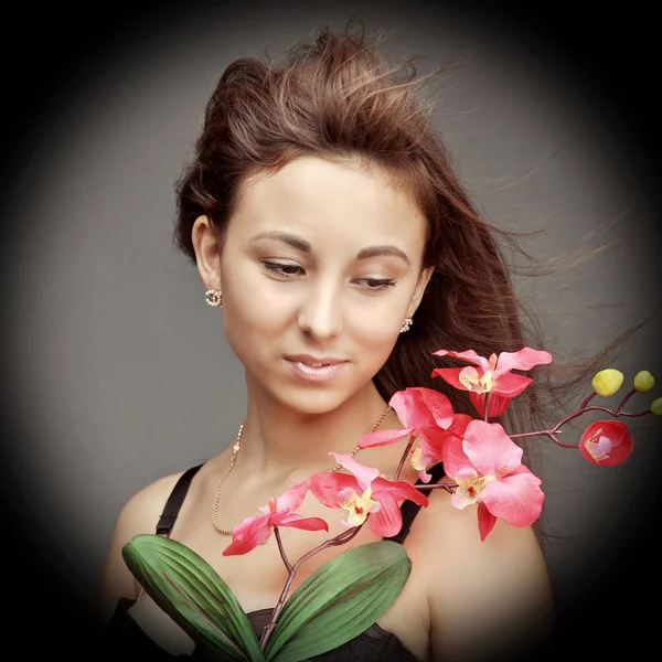 Young caucasian woman with orchid — Stock Photo, Image